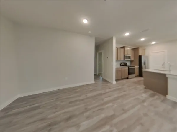 a view of a kitchen with a refrigerator and a microwave