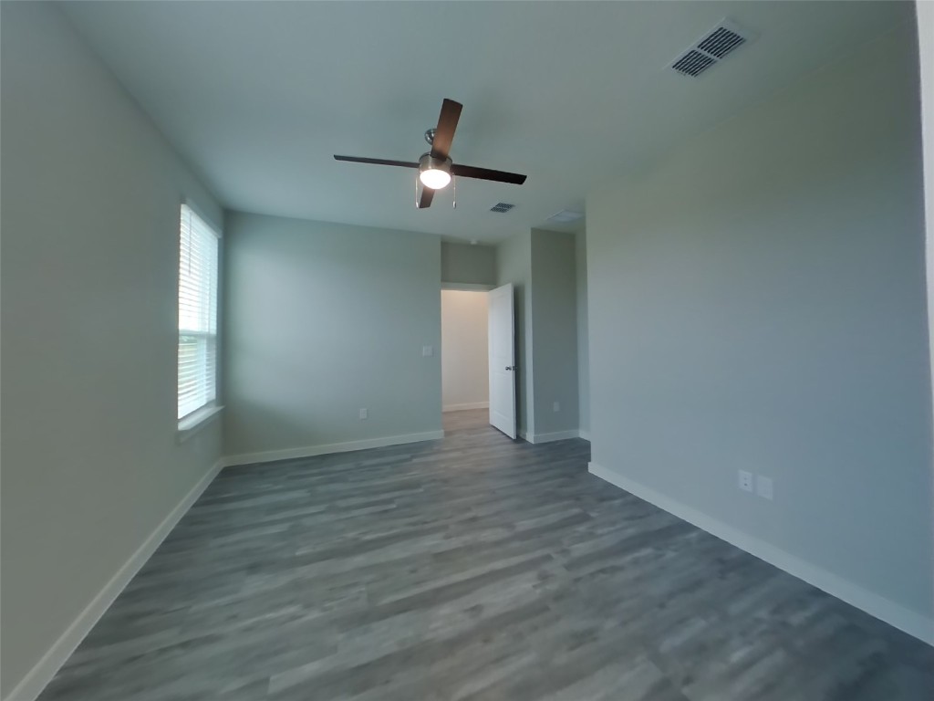 609 Foxtail Agave Street Leander, TX 78641 - Photo 7 of 29 wooden floor in an empty room with a window
