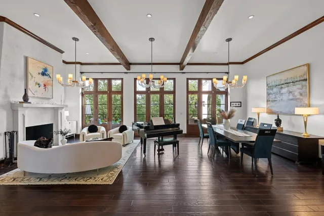 a living room with fireplace furniture and a large window
