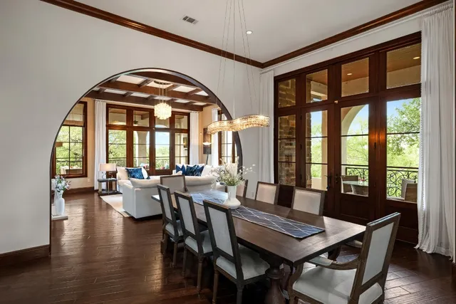 a view of a dining room with furniture large windows and wooden floor