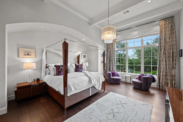 a bed room with a bed and a chandelier