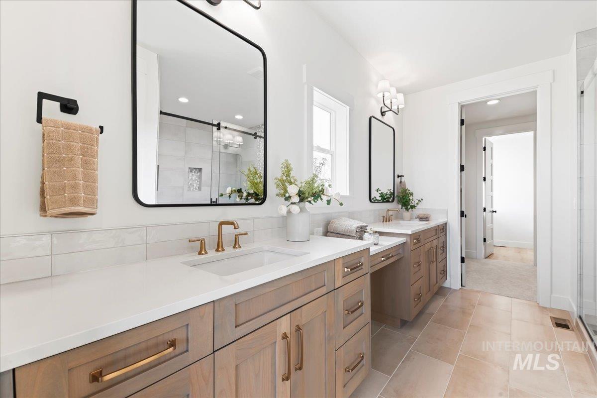 9580 South Prairie Falcon Avenue Nampa, ID 83686 - Photo 27 of 50 Bathroom with a shower stall, two vanities, light tile patterned flooring, and recessed lighting