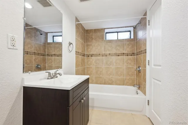 a bathroom with a sink mirror toilet and bathtub
