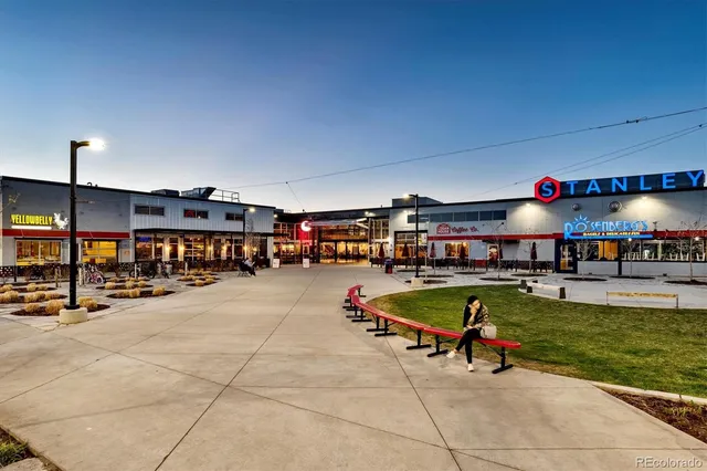a living room with furniture a pool table and a fireplace