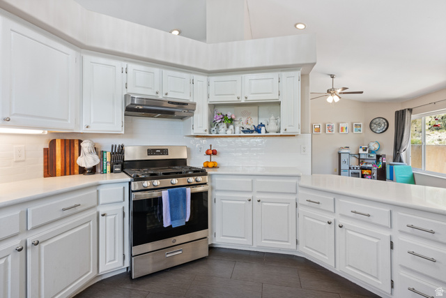 790 East Fiddlers Canyon Road Cedar City, UT 84721 - Photo 10 of 35 Modern kitchen featuring white cabinetry, a stainless steel range with matching hood, and white subway tile backsplash