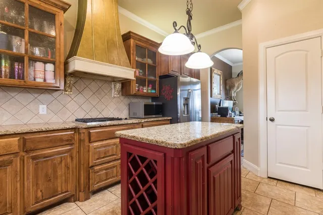 a kitchen with a sink a counter space and cabinets