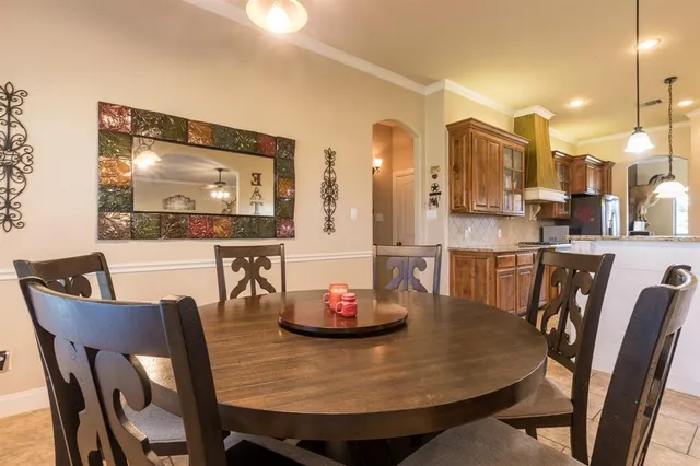 a dining room with furniture and a chandelier