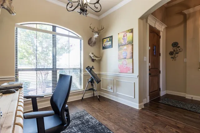 a view of a workspace with furniture window and wooden floor