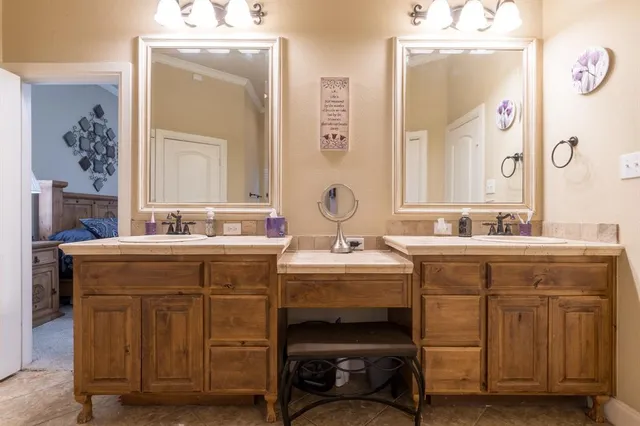 a spacious bathroom with a double vanity sink and a mirror