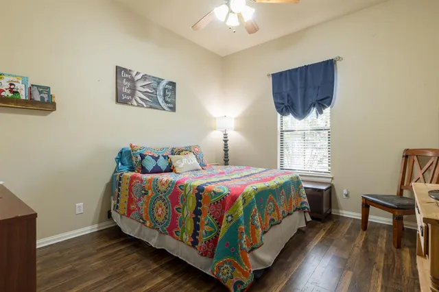 a bedroom with a bed a mirror and a window