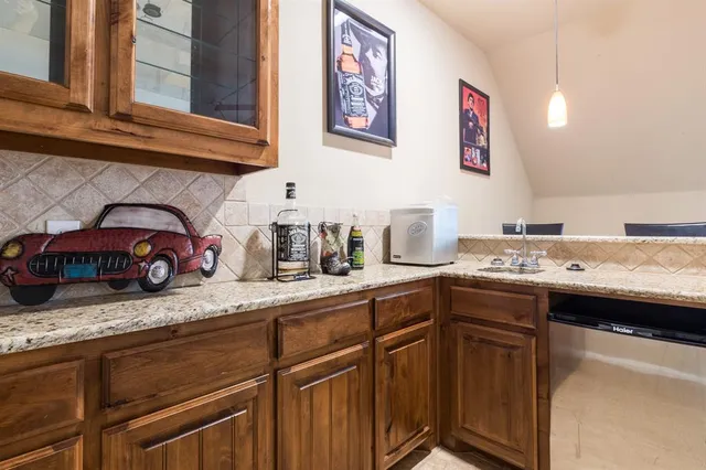 a kitchen with stainless steel appliances granite countertop a sink and cabinets