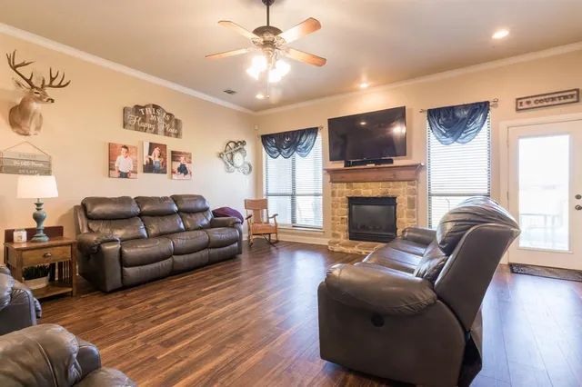 a living room with furniture a flat screen tv and a fireplace