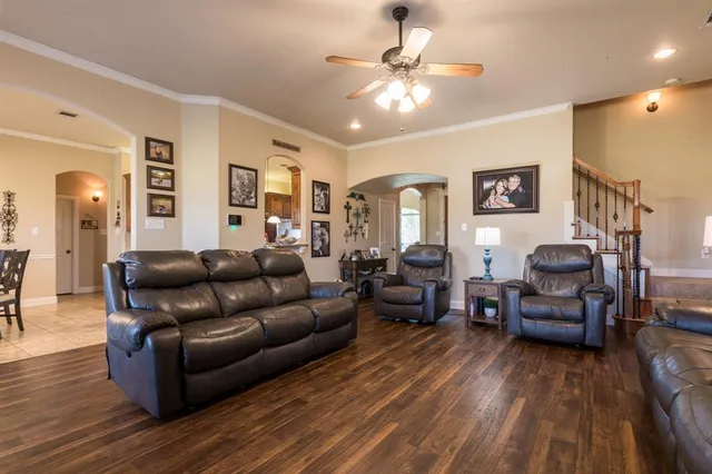 a living room with furniture and wooden floor