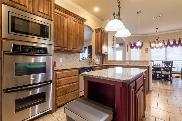 a kitchen with stainless steel appliances granite countertop a stove microwave and stove