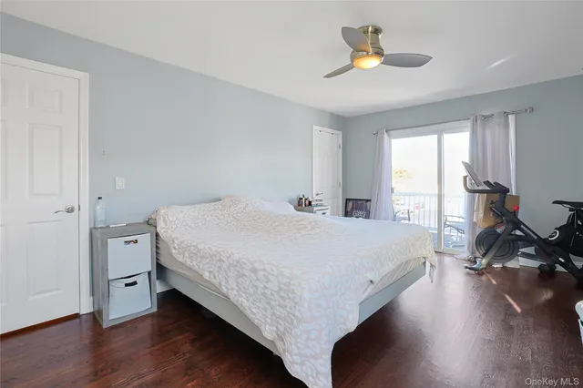 a bedroom with a bed and a flat tv screen on the dresser
