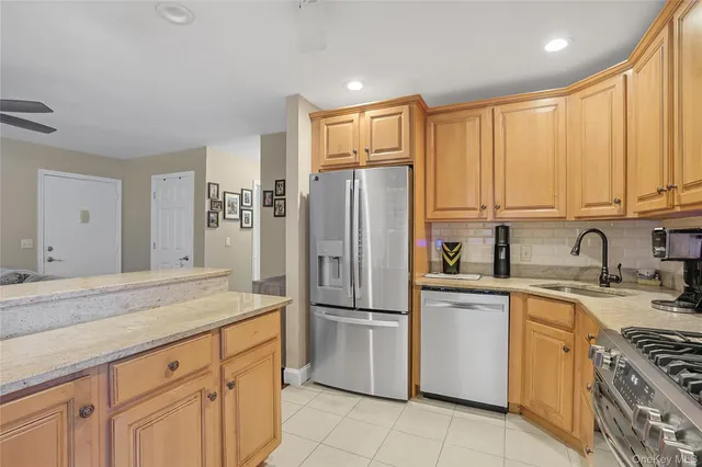 a kitchen with stainless steel appliances granite countertop a refrigerator sink and cabinets