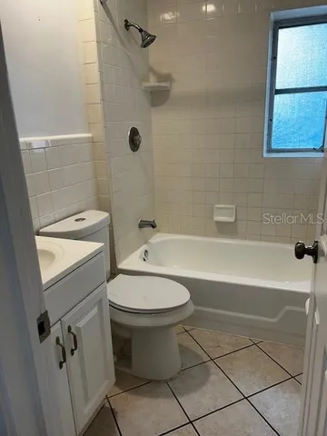 a bathroom with a toilet a sink and bathtub