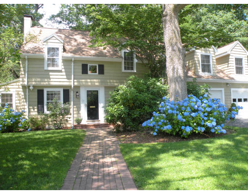 40 Cleveland Road Wellesley, MA 02481 - Photo 1 of 1 a front view of a house with a yard and flowers