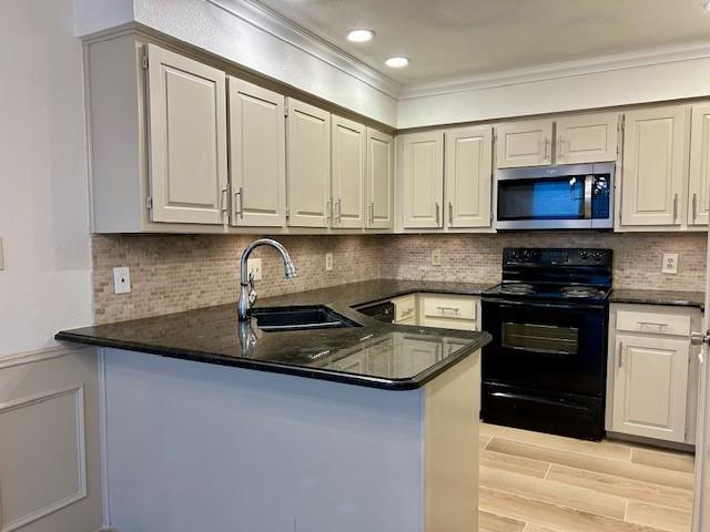 17119 Upper Bay Road Addison, TX 75001 - Photo 6 of 29 a kitchen with stainless steel appliances granite countertop a stove a sink and a microwave