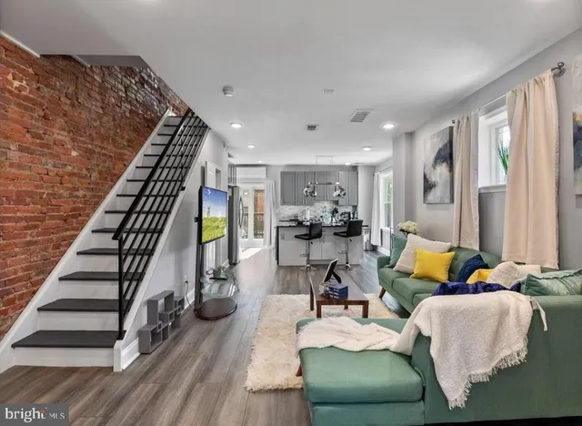 a living room with furniture and wooden floor