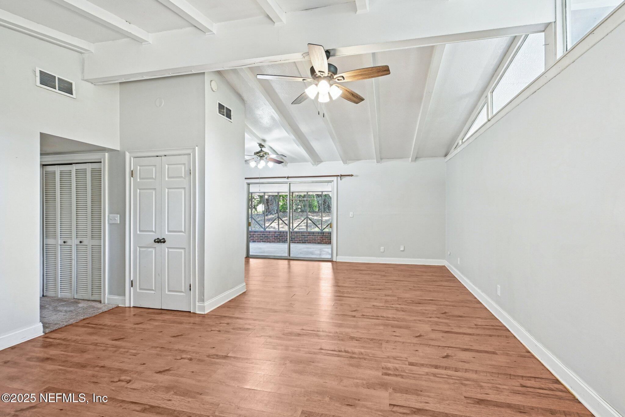 4619 Morris Road Jacksonville, FL 32225 - Photo 12 of 56 a view of an empty room with wooden floor and a window