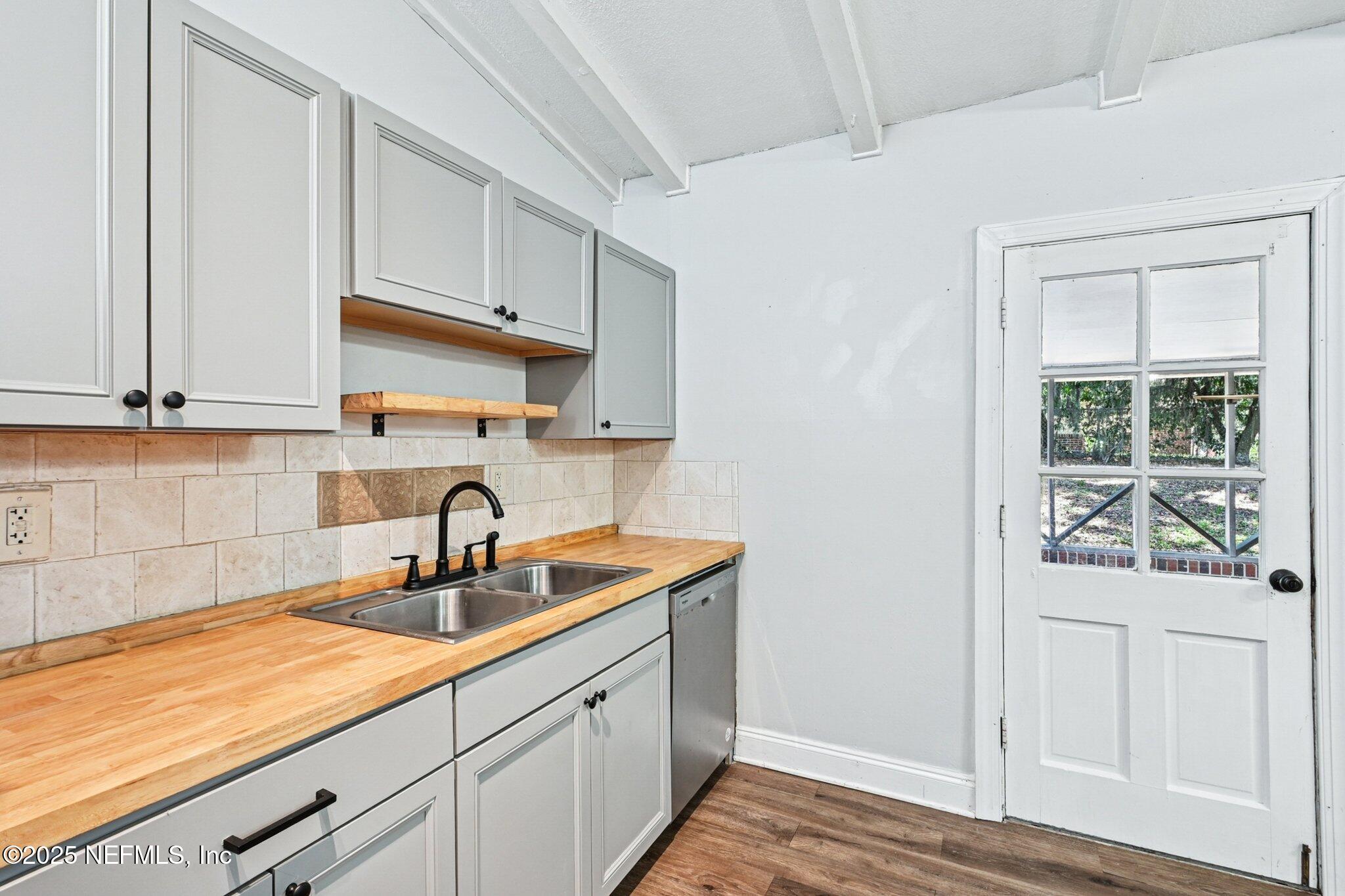 4619 Morris Road Jacksonville, FL 32225 - Photo 20 of 56 a kitchen with stainless steel appliances granite countertop a sink and a white cabinets
