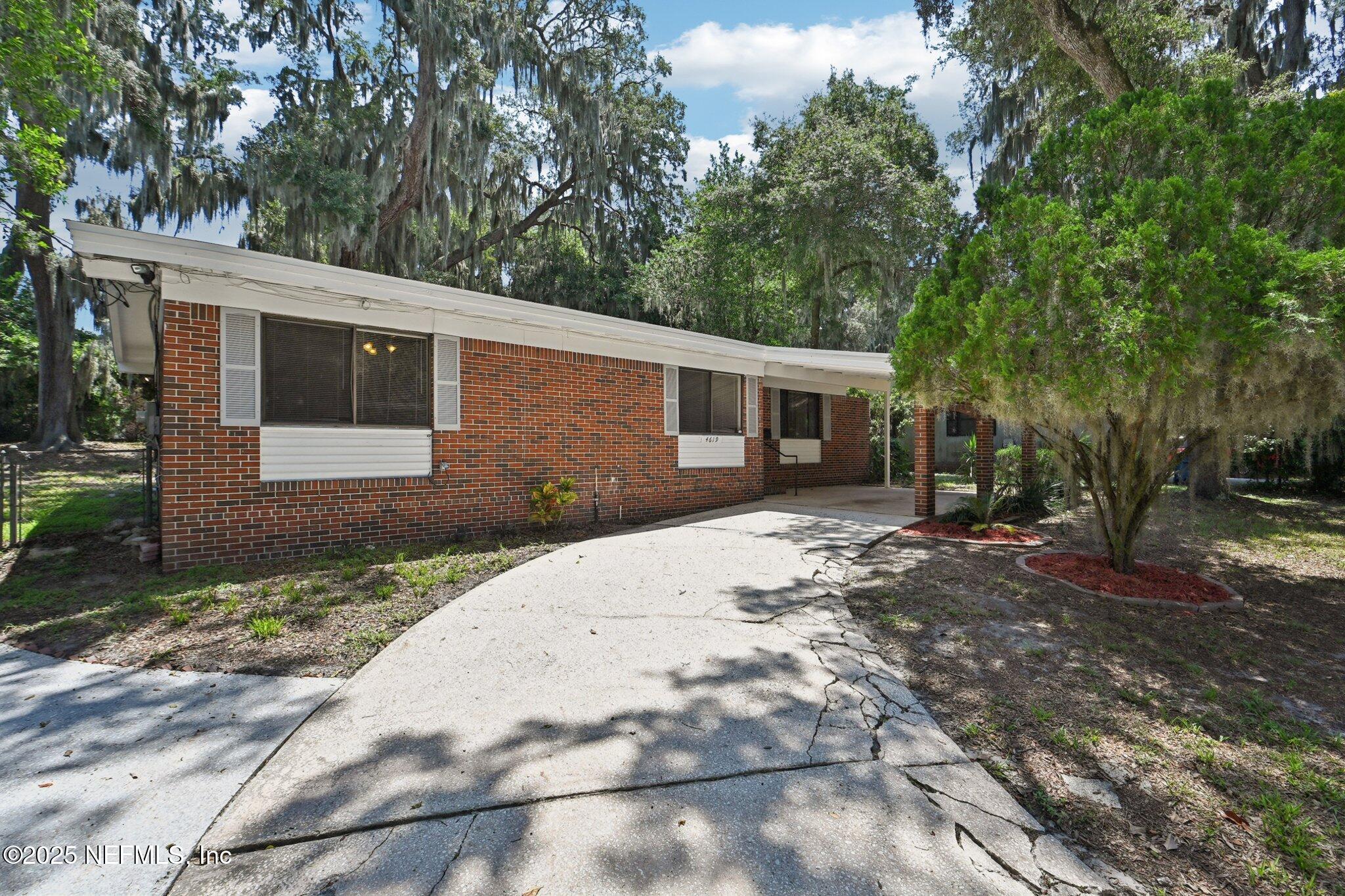 4619 Morris Road Jacksonville, FL 32225 - Photo 2 of 56 a front view of a house with a yard