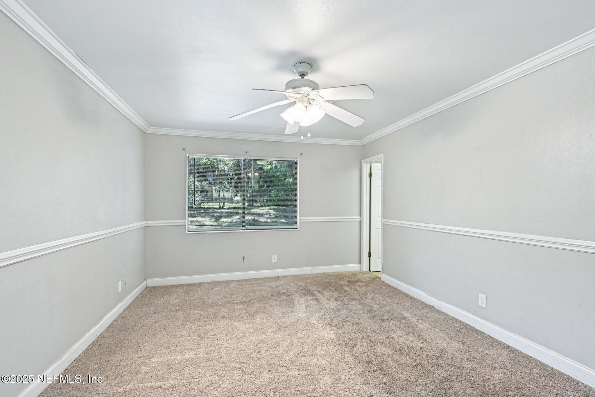 4619 Morris Road Jacksonville, FL 32225 - Photo 22 of 56 an empty room with a window and a fan