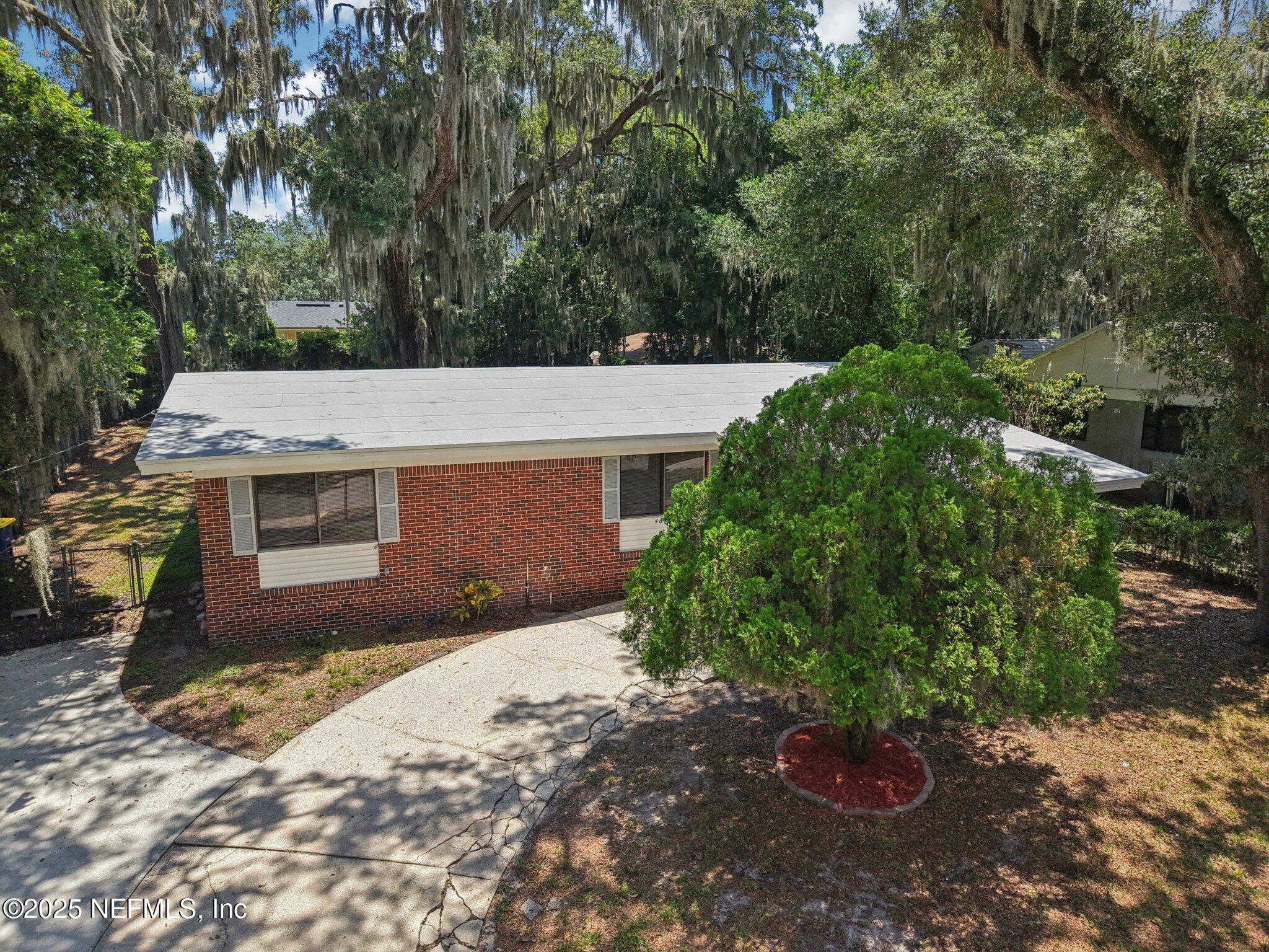 4619 Morris Road Jacksonville, FL 32225 - Photo 40 of 56 a backyard of a house with a yard and garage
