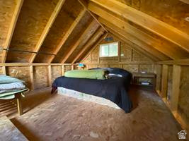 800 Homestead Road Road Cokeville, WY 83114 - Photo 35 of 49 Attic space with exposed wood framing, plywood flooring, and a single window