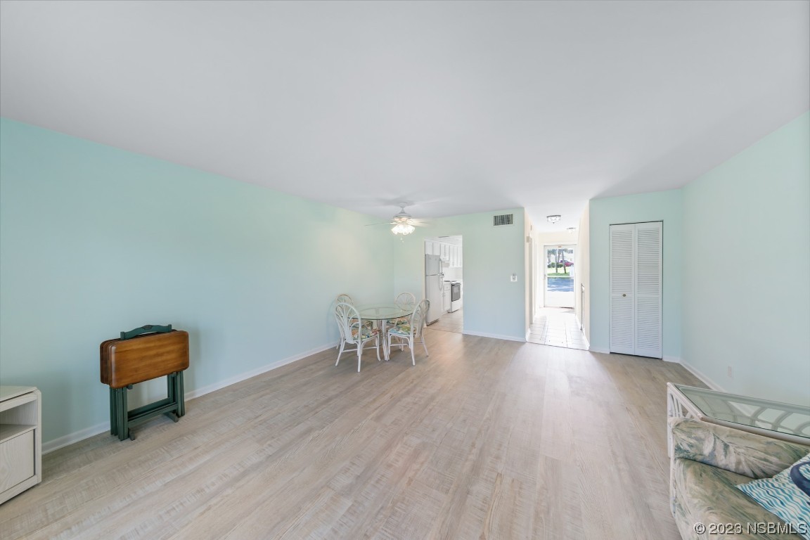 4790 South Atlantic Avenue, Unit F601 Ponce Inlet, FL 32127 - Photo 12 of 37 a view of a room with wooden floor lounge chair and a table