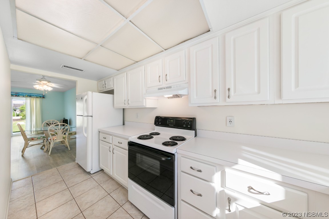 4790 South Atlantic Avenue, Unit F601 Ponce Inlet, FL 32127 - Photo 13 of 37 a kitchen with cabinets and appliances