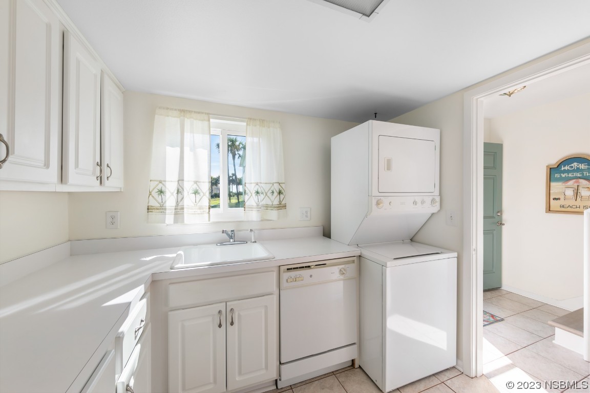 4790 South Atlantic Avenue, Unit F601 Ponce Inlet, FL 32127 - Photo 16 of 37 a kitchen with white cabinets and sink