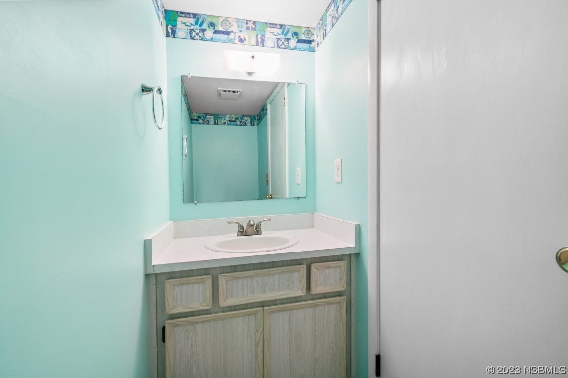 4790 South Atlantic Avenue, Unit F601 Ponce Inlet, FL 32127 - Photo 18 of 37 a bathroom with a sink and a mirror