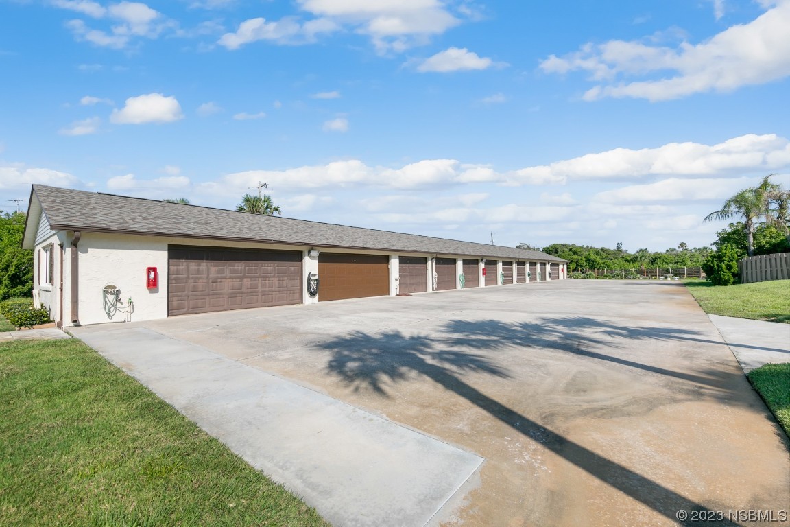 4790 South Atlantic Avenue, Unit F601 Ponce Inlet, FL 32127 - Photo 21 of 37 a front view of a house with a yard and garage