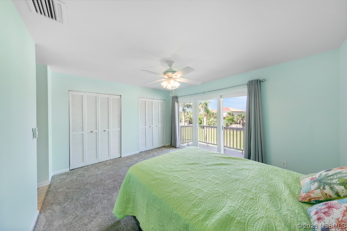 4790 South Atlantic Avenue, Unit F601 Ponce Inlet, FL 32127 - Photo 25 of 37 a bedroom with a large bed and a chandelier