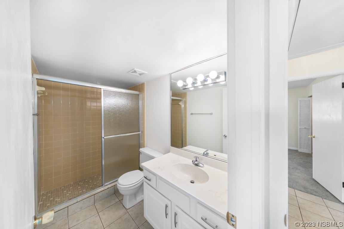 4790 South Atlantic Avenue, Unit F601 Ponce Inlet, FL 32127 - Photo 26 of 37 a bathroom with a toilet a sink a mirror and shower