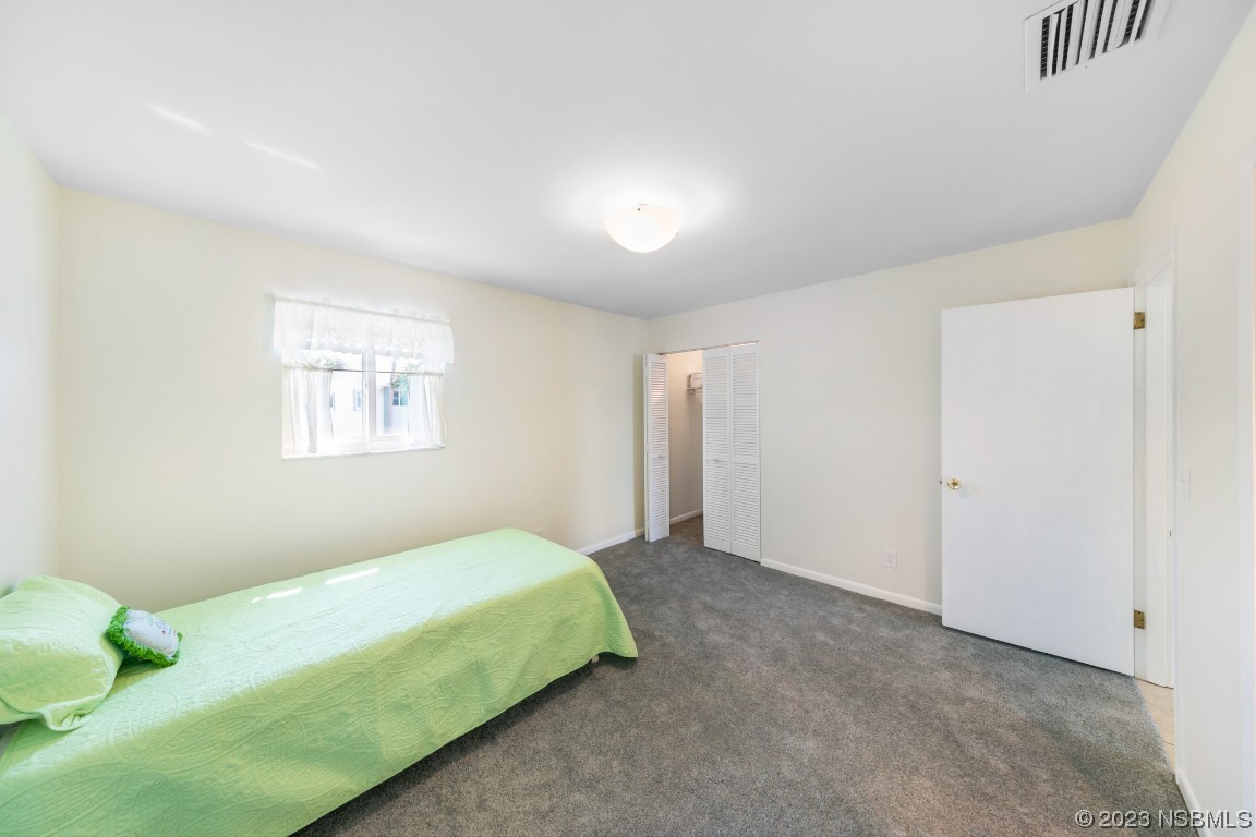 4790 South Atlantic Avenue, Unit F601 Ponce Inlet, FL 32127 - Photo 27 of 37 a bedroom with a bed and a window