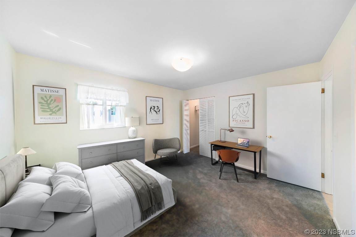 4790 South Atlantic Avenue, Unit F601 Ponce Inlet, FL 32127 - Photo 28 of 37 a bedroom with a bed and a couch