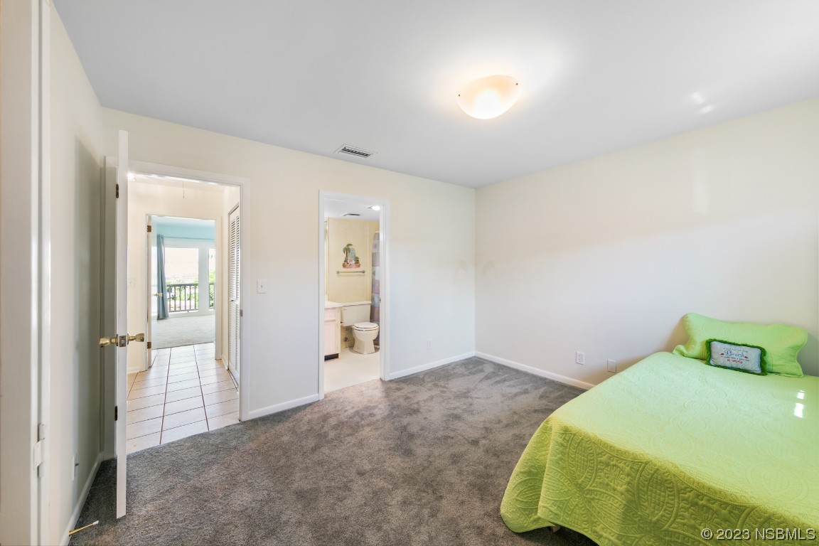 4790 South Atlantic Avenue, Unit F601 Ponce Inlet, FL 32127 - Photo 30 of 37 a bedroom with a bed and hallway