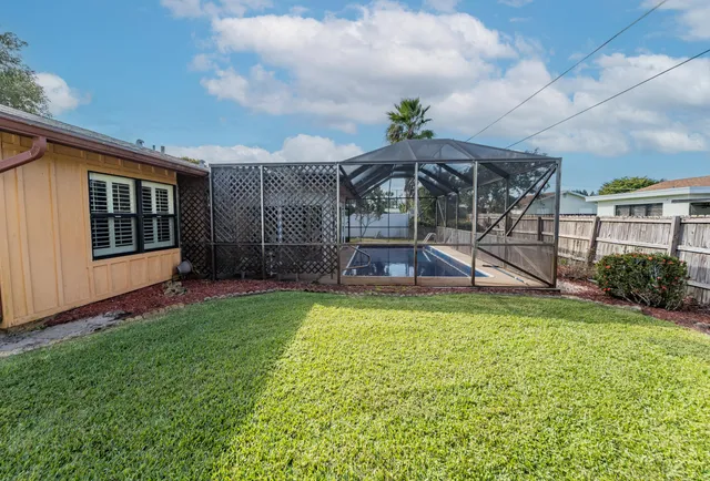 a view of a house with backyard porch and sitting area