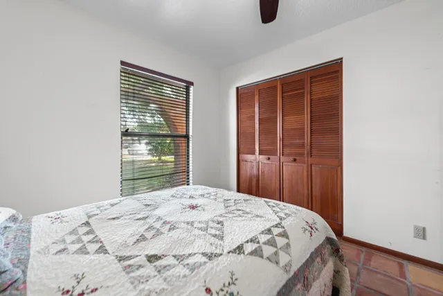 a bedroom with a bed and window