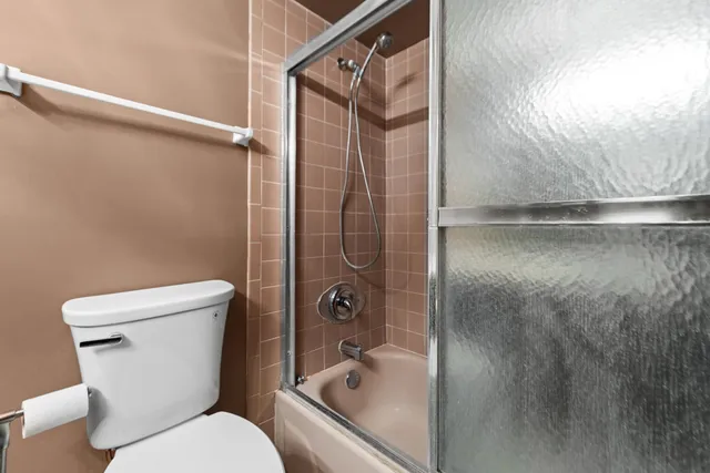 a bathroom with a shower and toilet