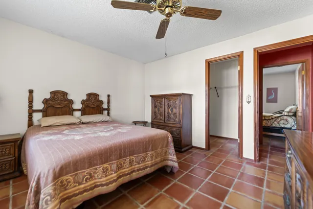 a bedroom with a bed and a mirror