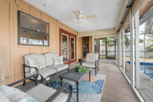 a living room with furniture and a floor to ceiling window