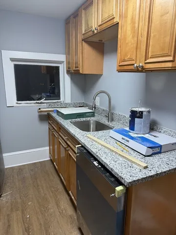 a kitchen with granite countertop a sink and a stove