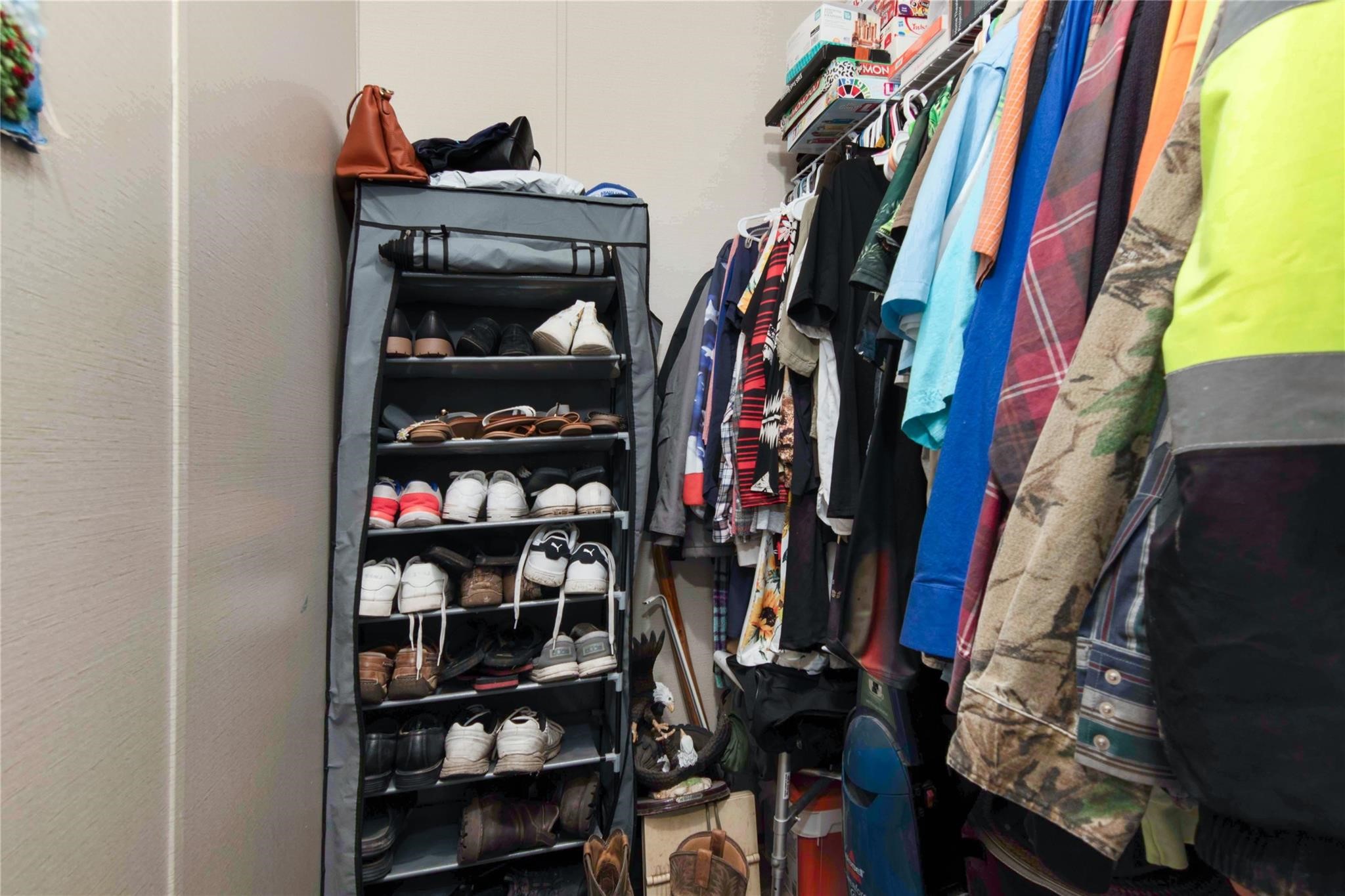 18093 Pickering Road Conroe, TX 77302 - Photo 22 of 29 a view of walk in closet with clothes and shoes