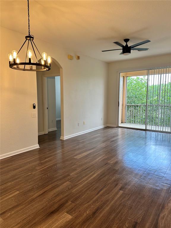 13584 Turtle Marsh Loop, Unit 132 Orlando, FL 32837 - Photo 8 of 21 a view of a room with wooden floor a ceiling fan and windows