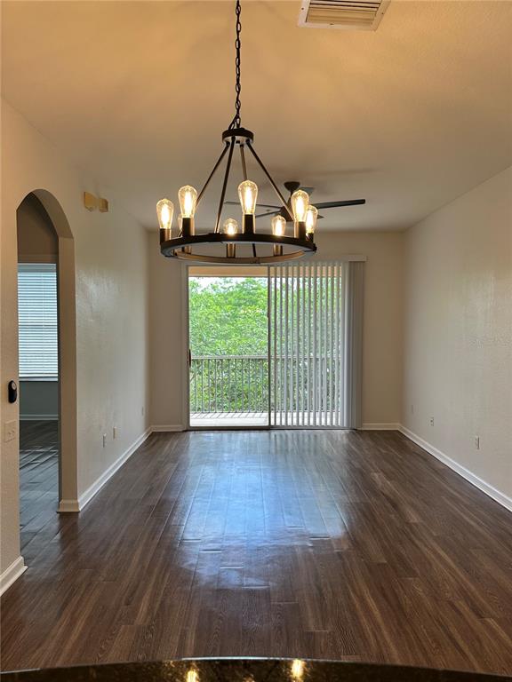 13584 Turtle Marsh Loop, Unit 132 Orlando, FL 32837 - Photo 9 of 21 a view of a room with wooden floor fan and windows