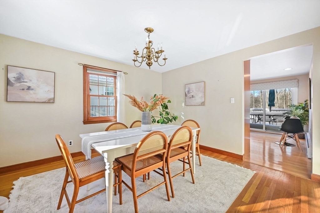 48 Grapevine Avenue Lexington, MA 02421 - Photo 11 of 34 a view of a dining room with furniture wooden floor and a chandelier